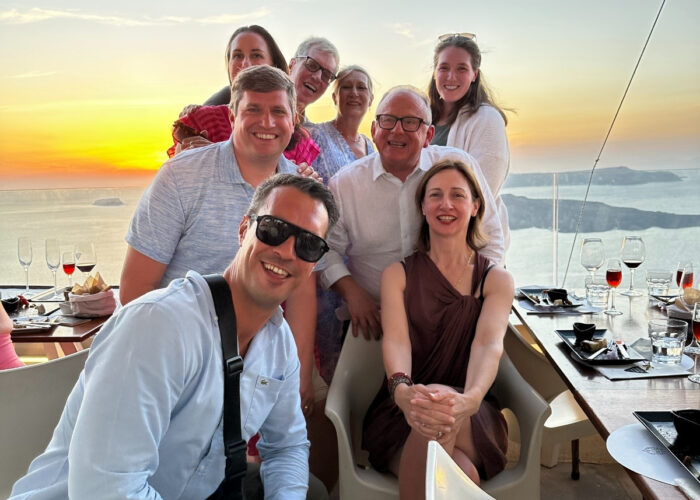 Breathtaking Santorini sunset over the caldera, painting the sky with vibrant orange and pink hues.